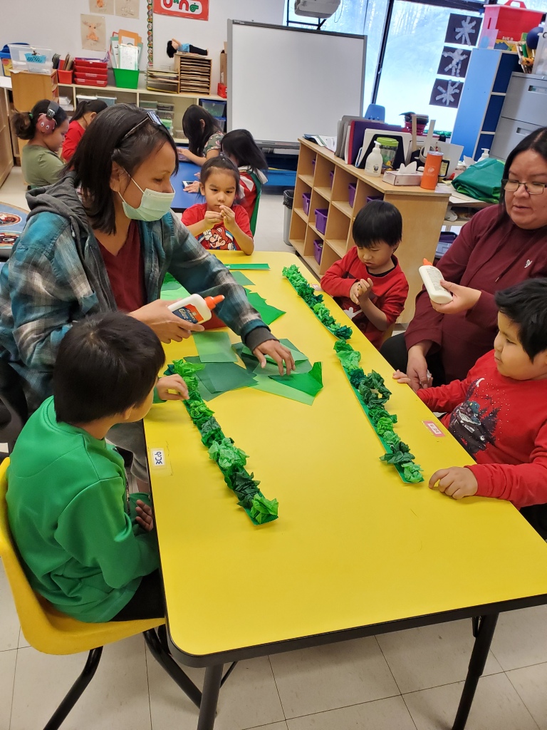 Students making Christmas Decorations with their teachers